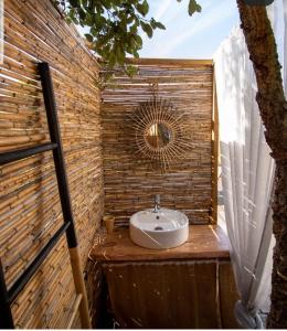 a bathroom with a sink on a brick wall at Sublim' Ecolodge in Abela