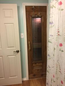 a bathroom door with a shower curtain with flowers on it at Trinity House Rm B in Fairbanks