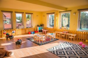 a childs room with yellow walls and wooden furniture at Pensjonat Szczebel in Mszana Dolna