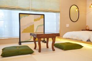 a bedroom with a mirror and a table and a bed at Asakusa New City Hotel in Tokyo +29 photos