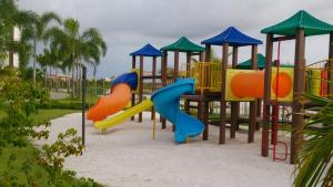 a playground with a slide in the sand at Condominio Mediterraneo - Iberostate in Praia do Forte