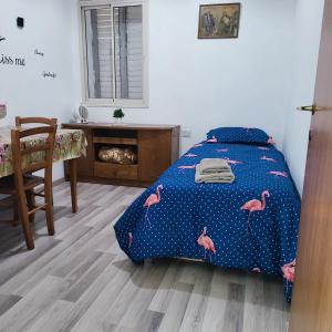 a bedroom with a bed with pink flamingos on it at EMAN SWEET HOME - cozy privet unique apartment in haifa downtown in Haifa