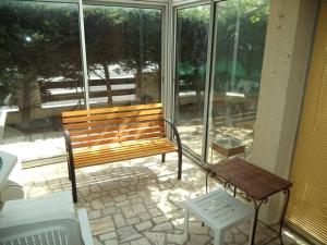 a bench and a table on a patio with windows at Appartement Narbonne, 4 pièces, 4 personnes - FR-1-229B-473 in Narbonne
