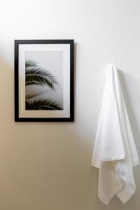 a picture of a palm tree on a wall with a towel at Villa L3 by Stay Samui - Bohemian Chic in Koh Samui 