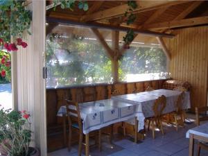 a dining room with tables and chairs and a window at Judit haus in Balatonfüred