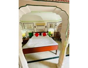 a bed with a canopy in a room at Singhasan Haveli, Mandawa in Mandāwa