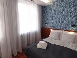 a bedroom with a bed with a blue and white wall at Apartamenty na Starówce Grobla in Gdańsk