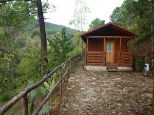 a wooden cabin in the middle of a forest at Camping La Eliza in Lanzahita