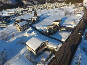 an aerial view of a town covered in snow at NIKONOS III in Nozawa Onsen