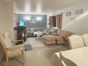 a living room with a couch and a table at 8 person holiday home in STONGLANDSEIDET in Stonglandseidet +31 photos