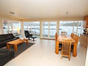 a living room with a table and chairs and a view of the water at Holiday Home Foreneset in Jelsa