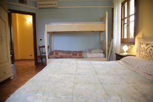 a bedroom with two bunk beds in a room at Su Livariu in Siamaggiore +7 photos