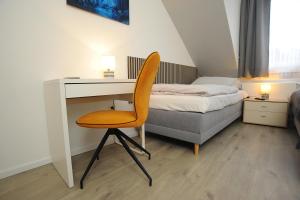 a desk with a chair and a bed in a room at Swetis Passage in Pulheim