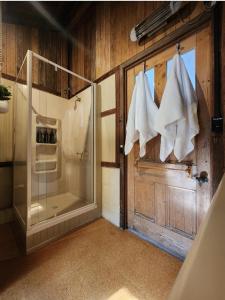 a bathroom with a shower and a glass door at DAYLESFORD Frog Hollow Estate THE BARN - Wanting a different experience - Stay in the Barn - Table Tennis Table - Cinema Projector - Bar - Wood Fireplace - 3 QUEEN BEDS - A fun place for everyone in Daylesford