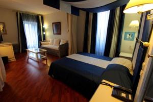 Postel nebo postele na pokoji v ubytování Hotel Moderne Et Pigeon