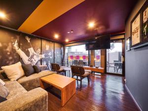 a living room with a couch and a table at Rakuten STAY x EAGLES 101 with terrace in Sendai