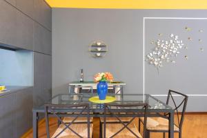 a dining room with a glass table and chairs at Castello Duomo Milano in Milan +33 photos