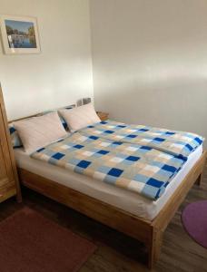 1 cama con colchón de color azul y blanco a cuadros en Ferienwohnungen Koch en Marburg an der Lahn