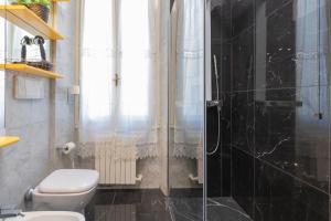 a bathroom with a toilet and a shower at Castello Duomo Milano in Milan