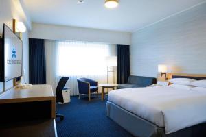 a hotel room with a bed and a desk at Hotel Nikko Narita in Narita