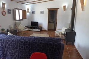 a living room with a couch and chairs and a fireplace at Cuevas Don Alvaro y Romaide 