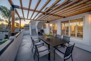 a patio with a wooden table and chairs at Steps To #PismoBeach with Poker, Foosball, FREE EV Charger, and Bikes in Oceano
