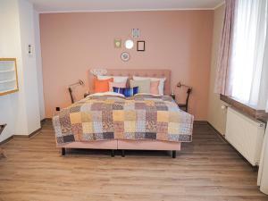 a bedroom with a bed with a colorful quilt at Boutique Hotel Stadtmitte in Mülheim an der Ruhr