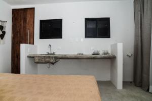 a bathroom with a sink and a bed at Samsara Tulum Boutique in Tulum