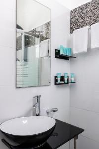 W łazience znajduje się umywalka i lustro. w obiekcie Residence Suites BY RAPHAEL HOTELS w Tel Awiwie