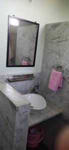 a bathroom with a sink and a mirror at lalita homestay countryside in Khajurāho