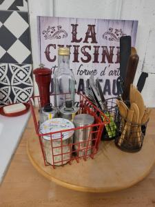 a basket of utensils and a bottle on a table at Sur les bords de Loire in Montlouis-sur-Loire