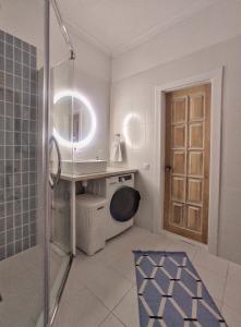 a bathroom with a shower and a sink and a mirror at NORDIC уютный домик в скандинавском стиле в горах Алматы in Besqaynar