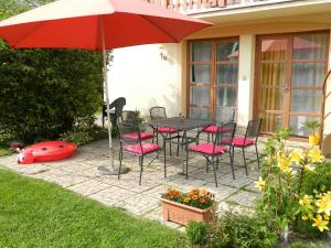 a patio with a table and chairs and an umbrella at Katka a Martin samostatný apartmán s vlastným vchodom in Liptovský Mikuláš