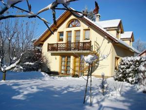 a house with a balcony in the snow at Katka a Martin samostatný apartmán s vlastným vchodom in Liptovský Mikuláš