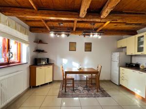 a kitchen with a table and chairs in a room at Chatka Baby Jagi in Ściegny