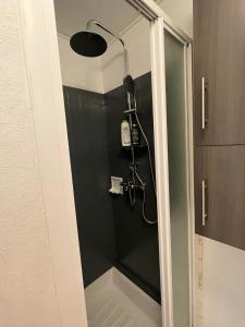 a shower with a shower head in a bathroom at Cozy studio au centre du village & superbe vue in Les Contamines-Montjoie