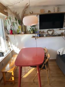 a red table and chair in a living room at Cozy studio au centre du village & superbe vue in Les Contamines-Montjoie