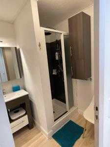 a small bathroom with a shower and a sink at Cozy studio au centre du village & superbe vue in Les Contamines-Montjoie