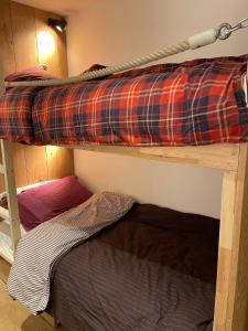 a couple of bunk beds in a room at Cozy studio au centre du village & superbe vue in Les Contamines-Montjoie