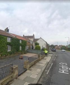 a person standing on the side of a street at Ivy Cottage in Eston