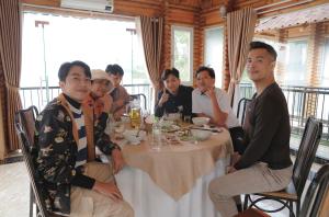 a group of people sitting around a table at Phu Ninh Lake Resort & Spa in Tam Ky