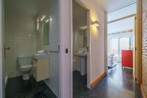 a bathroom with a toilet and a sink and a window at HomeHolidaysRentals Miracel - Costa Barcelona in Malgrat de Mar +38 photos