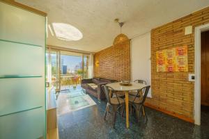 a living room with a table and a couch at HomeHolidaysRentals Miracel - Costa Barcelona in Malgrat de Mar