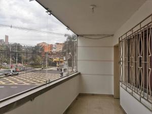 an empty room with a large window and a street at Casa piso 2 sin ascensor Medellín Centro lugar seg in Medellín
