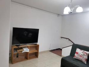 a living room with a large flat screen tv at Casa piso 2 sin ascensor Medellín Centro lugar seg in Medellín