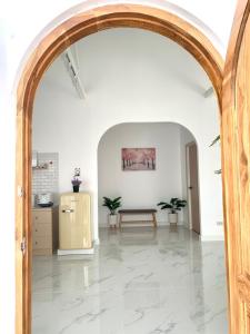 an archway leading into a room with a table at Zenzen Pool Villa in Chiang Mai