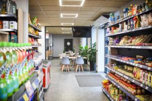 an aisle of a store with a table in the background at Motel Na Skarpie in Bielsko-Biała