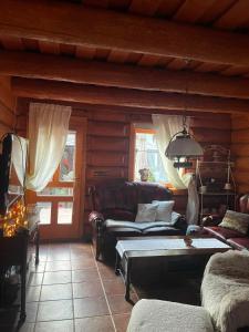 a living room with a couch and a table at Chata Lišiačik in Tajov