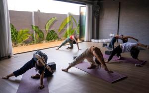 a group of people doing yoga in a room at Bedradio Dodubong in Jeju