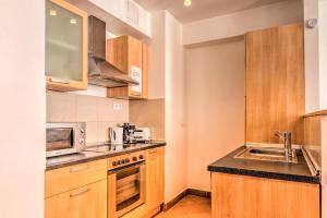 a kitchen with a sink and a microwave at Budapest City Center Apartments in Budapest